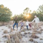 Fall mini sessions near me by Alison Bell, photographer. Family of five in a sandy field with tall grass