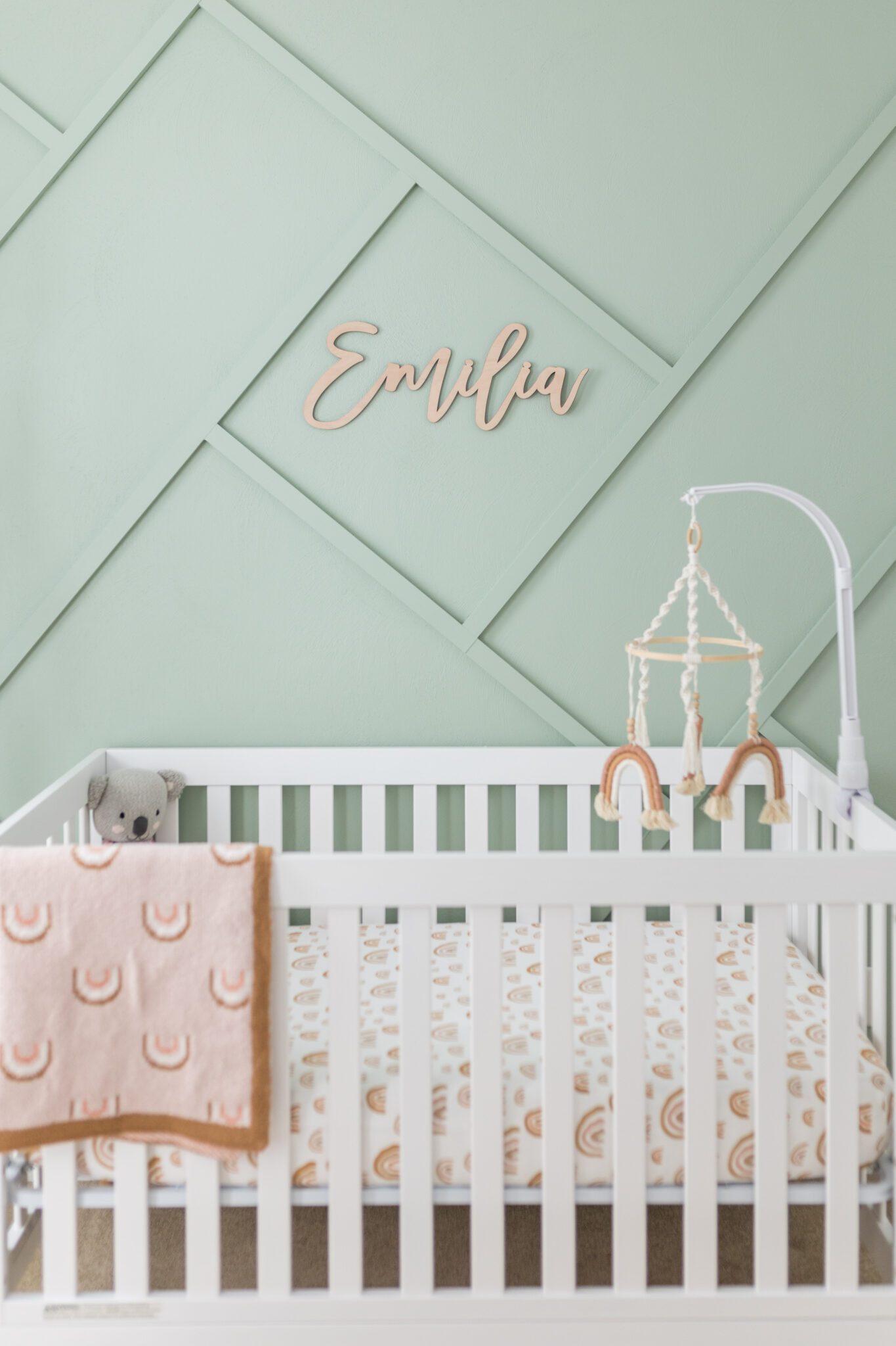 hawaii newborn photography by alison bell photographer. nursery wall detail with moulding, baby's name over the crib