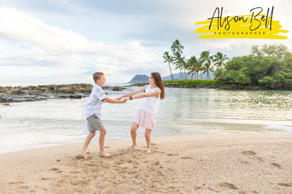 kids playing in sand paradise cove beach, ko olina, oahu