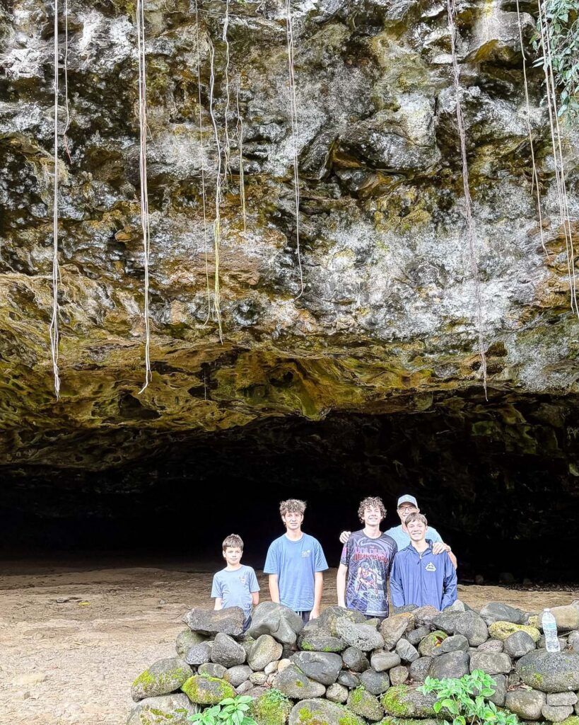 Family exploring a cave on the North Shore of Kauaʻi, Hawaii. Photography by Alison Bell, photographer in Hawaii.
