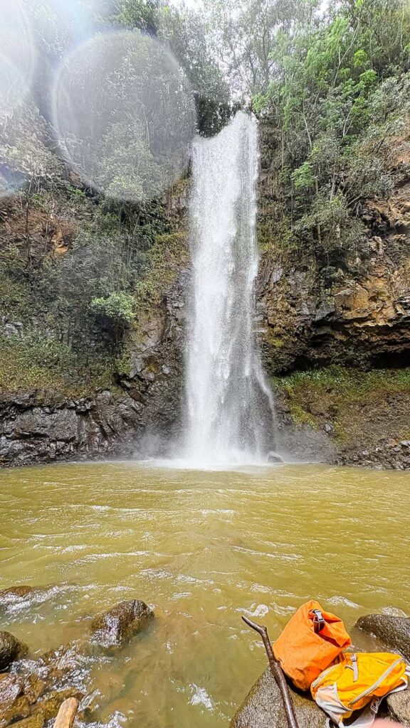 Waterfall at Secret Falls after a muddy hike in Kauaʻi, Hawaii. Photography by Alison Bell, photographer in Hawaii.