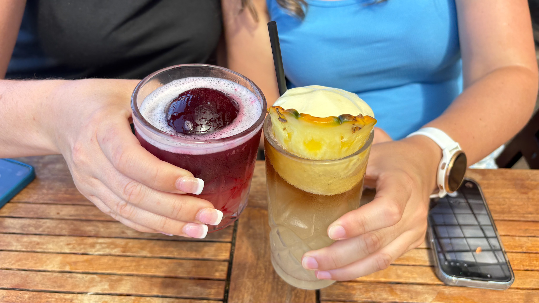 Two colorful drinks at Kahuku Beer Garden, a casual outdoor stop for food and drinks on Oahu. Photography by Alison Bell, photographer in Hawaii.